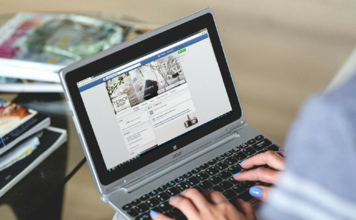 Women using Facebook on a laptop computer